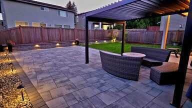Stylish backyard patio with seating, pergola, and landscape lighting. Perfect outdoor space.